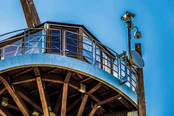 a flir pt series camera mounted to a pole on a park watch tower