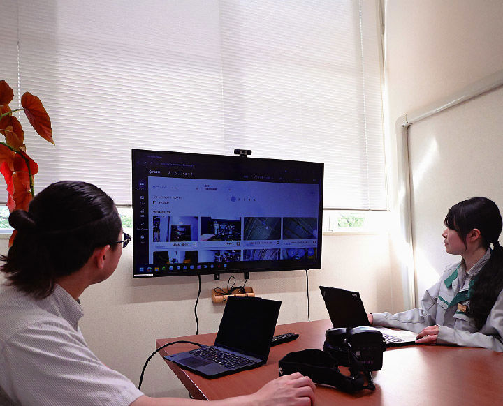 a man and a woman looking at a computer screen filled with acoustic images