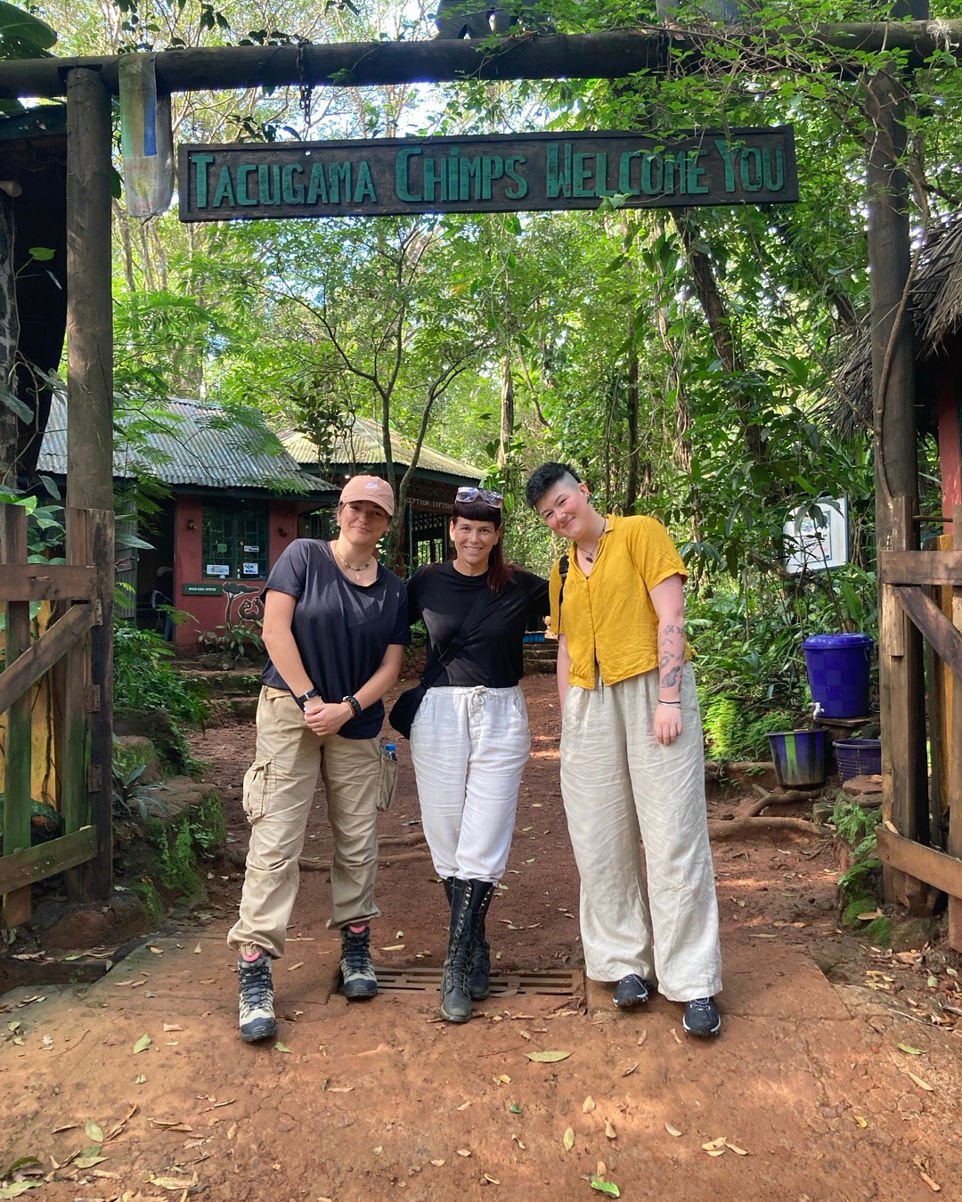 Gillian Forrester posing with her fellow researchers in front of a compound